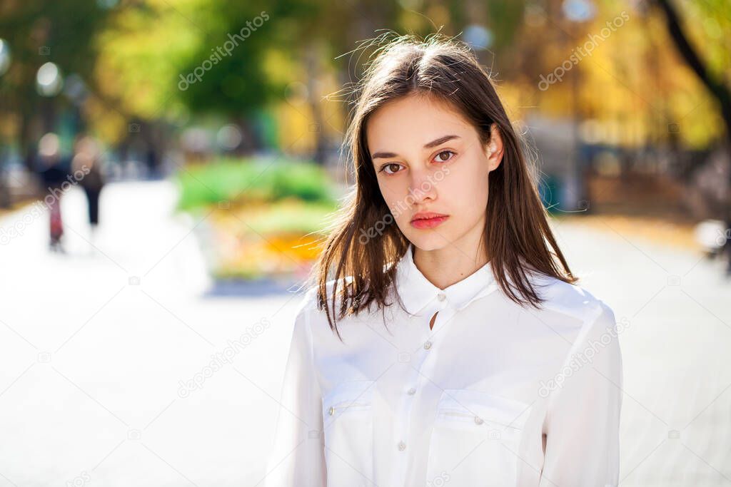 Close up portrait of a young beautiful girl in white shirt