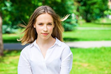 Yaz parkında genç ve güzel bir esmer kızın portresi.