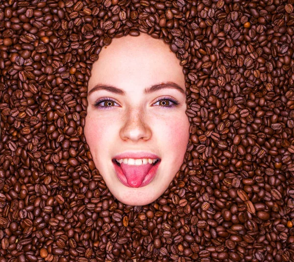 Portrait of a young girl in coffee beans top view