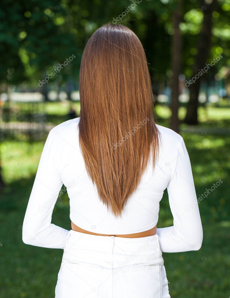 Back rear view brunette hair model, summer park outdoor