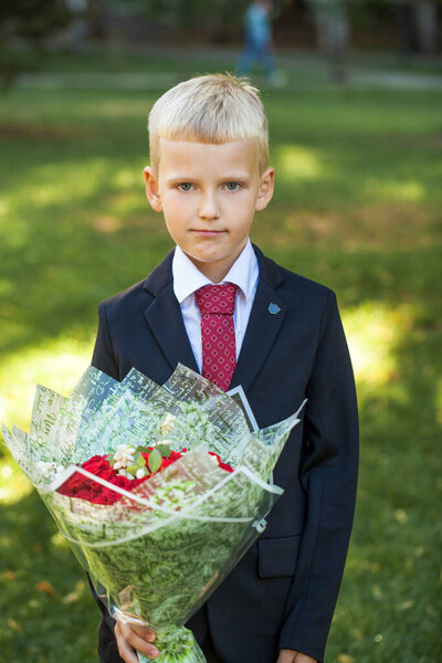 First grader, portrait of a young handsome boy in school uniform