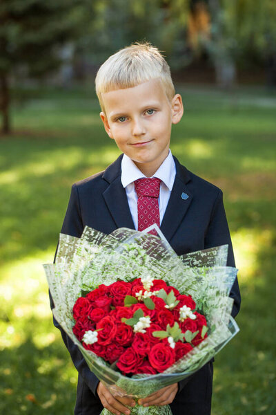 First grader, portrait of a young handsome boy in school uniform