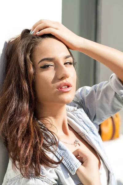 Young woman against white wall — Stock Photo, Image