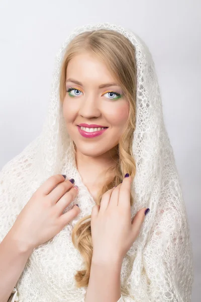 Beautiful blonde girl in a white shawl — Stock Photo, Image