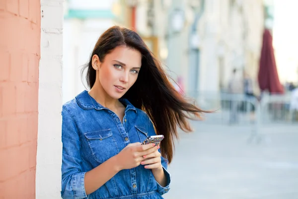 Junge Frau liest eine Nachricht am Telefon — Stockfoto