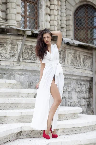 Portrait of young woman in long white dress — Stock Photo, Image