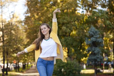 mutlu genç kadın sokak sonbaharda sarı ceket