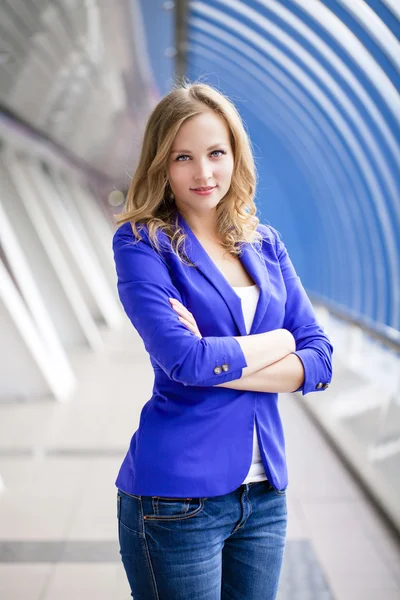 Beautiful young blonde in a blue jacket — Stock Photo, Image