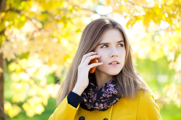 Happy beautiful woman calling by phone