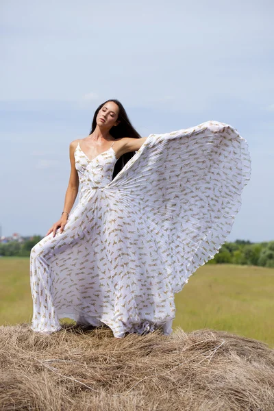 Beautiful young woman in white sexy dress — Stock Photo, Image