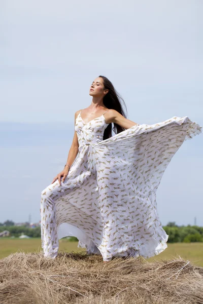 Beautiful young woman in white sexy dress — Stock Photo, Image