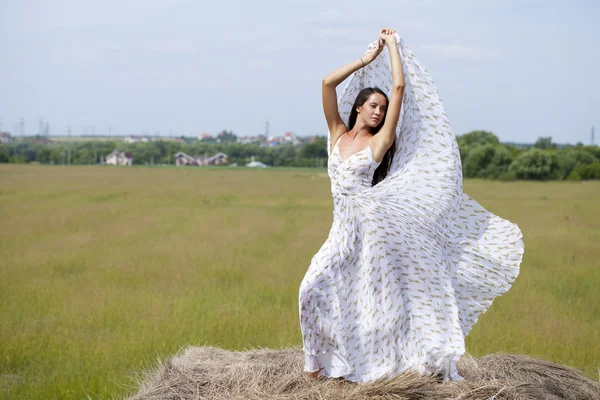 Beautiful young woman in white sexy dress — Stock Photo, Image