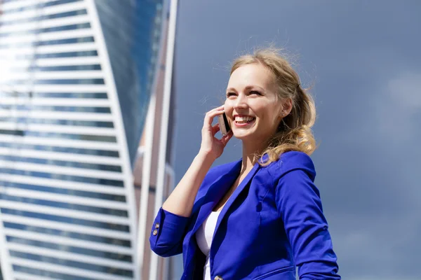 Beautiful young blonde calling by phone — Stock Photo, Image