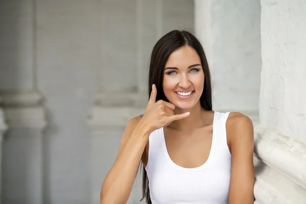 Beautiful woman making a call me gesture — Stock Photo, Image