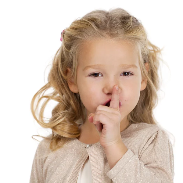 Little girl has put forefinger to lips as sign of silence — Stock Photo, Image