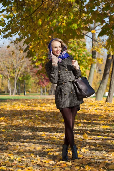 Young beautiful woman in white coat — Stock Photo, Image