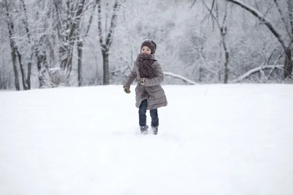 Gelukkig meisje draait op de achtergrond van sneeuw bedekt wint — Stockfoto