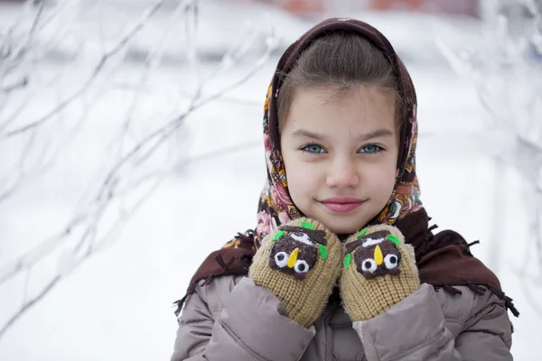 Happy little girl on the background of a winter park — Stok Foto