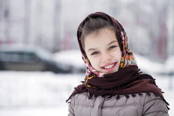 Happy little girl on the background of a winter park — Stok Foto