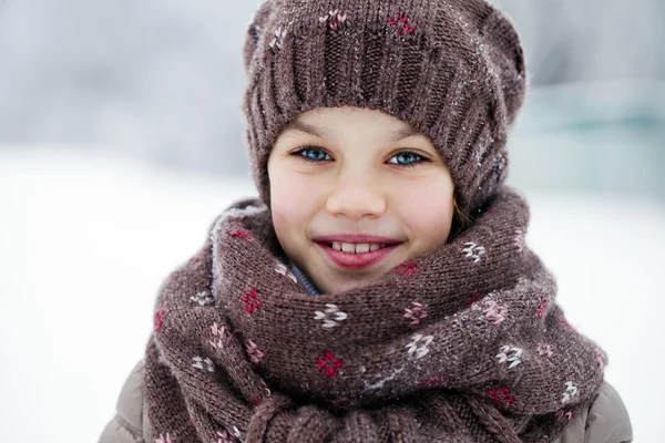 Happy little girl on the background of a winter park — Stok Foto