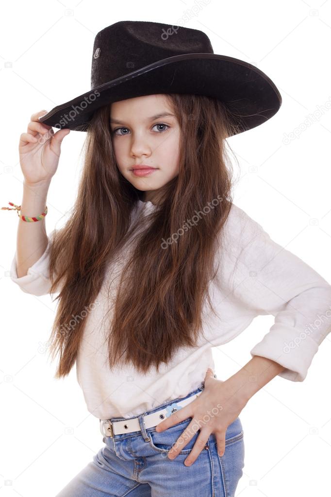 Portrait of a beautiful little girl in a black cowboy hat