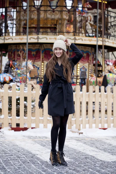 Happy young brown haired woman on the background of a winter amu — Stock Photo, Image