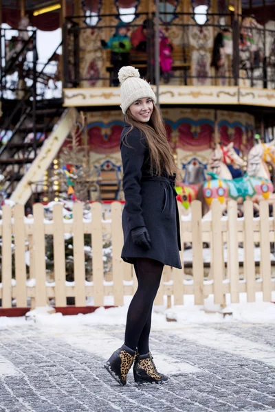 Happy young brown haired woman on the background of a winter amu — Stock Photo, Image