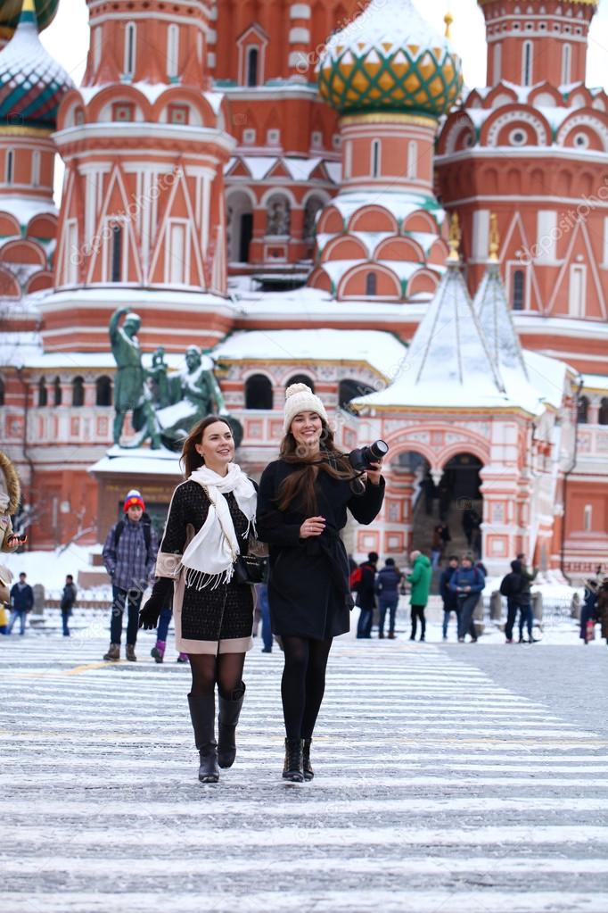 Two girls tourists are photographed in Moscow (Russia) 