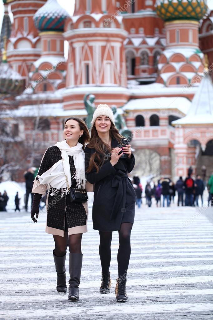 Two girls tourists are photographed in Moscow (Russia) 