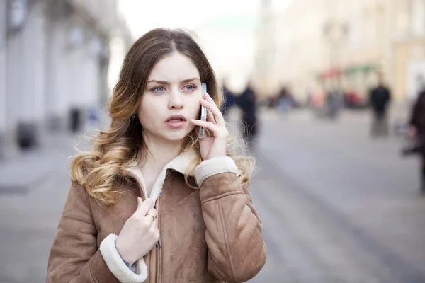 Beautiful young blonde calling by phone — Stock Photo, Image