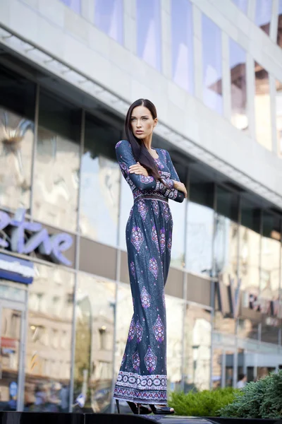 Beautiful young woman in colorful dress — Stock Photo, Image