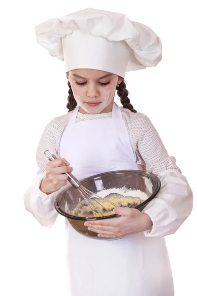 Little girl cook whips whisk eggs in a large plate — Stock Photo, Image