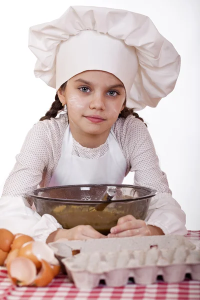 Matlagning och människor koncept - leende liten flicka i cook mössa — Stockfoto