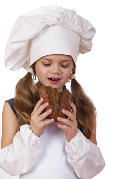 Vaření a lidé koncept - usmívající se holčička v kuchař klobouk — Stock fotografie