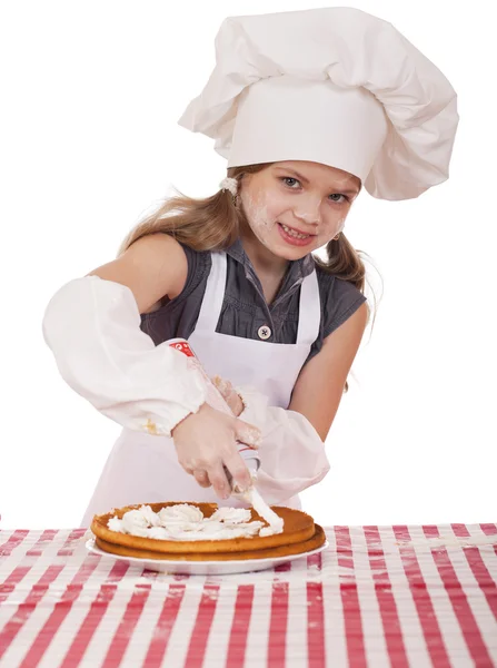 Beautiful happy seven year old girl in chef uniform with shortca — Stock Photo, Image