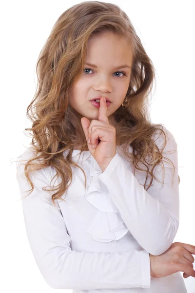 Little girl has put forefinger to lips as sign of silence — Stock Photo, Image