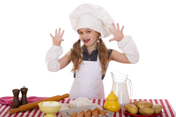 Bonito menina assar na cozinha e mostra as mãos — Fotografia de Stock