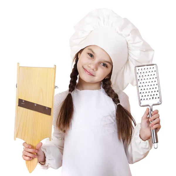 Beautiful little girl in a white apron and holding a wooden grat — Stock Photo, Image