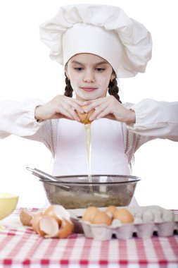 Küçük aşçı kız beyaz bir önlük yumurtaları derin bir tabak içinde tatili.