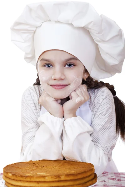 Matlagning och människor koncept - leende liten flicka i cook mössa — Stockfoto