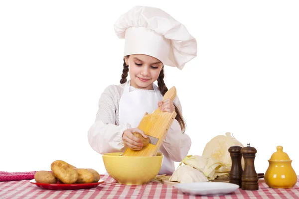 Beautiful little chief cooker on the desk with vegetables — Stock Photo, Image