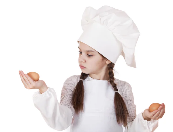 Portrait of a little girl in a white apron holding two chicken e — Stock Photo, Image