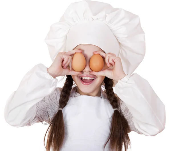 Portrait of a little girl in a white apron holding two chicken e — Stock Photo, Image