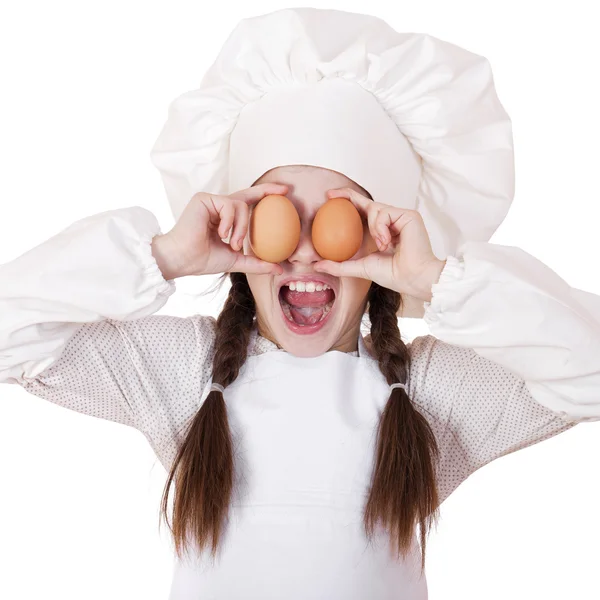 Portrait of a little girl in a white apron holding two chicken e — Stock Photo, Image