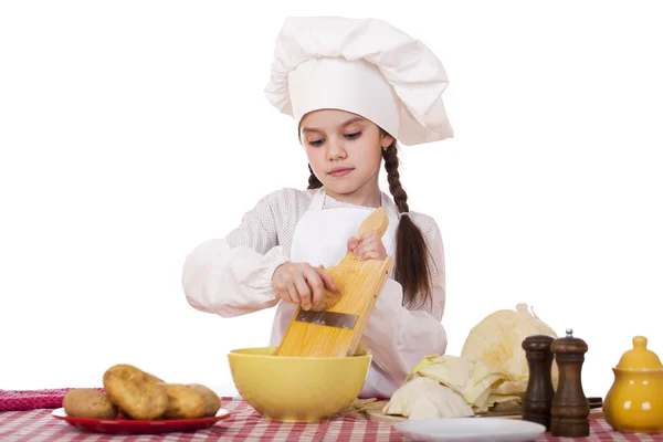 Beautiful little chief cooker on the desk with vegetables — Stock Photo, Image