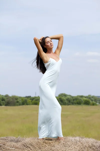 Beautiful young woman in white sexy dress — Stock Photo, Image