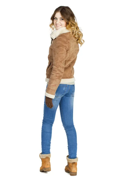 Young beautiful girl in a leather sheepskin coat and blue jeans — Stock Photo, Image