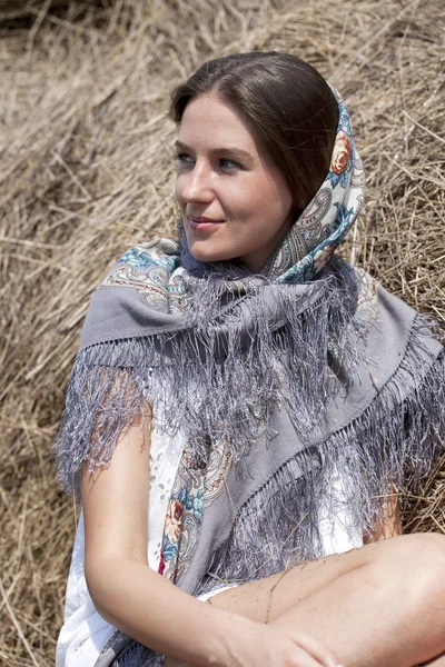 Portrait of a beautiful young woman in a blue scarf — Stock Photo, Image