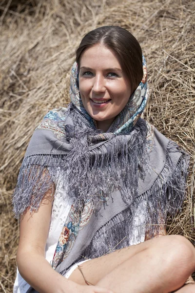 Portrait of a beautiful young woman in a blue scarf — Stock Photo, Image