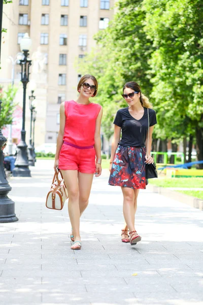 Två unga kvinnor promenader i sommar stad — Stockfoto